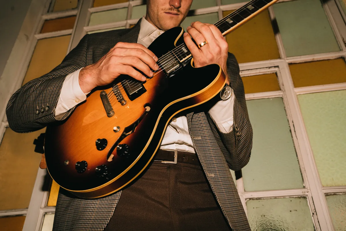 Close up of Jem Pryse's hands on a guitar